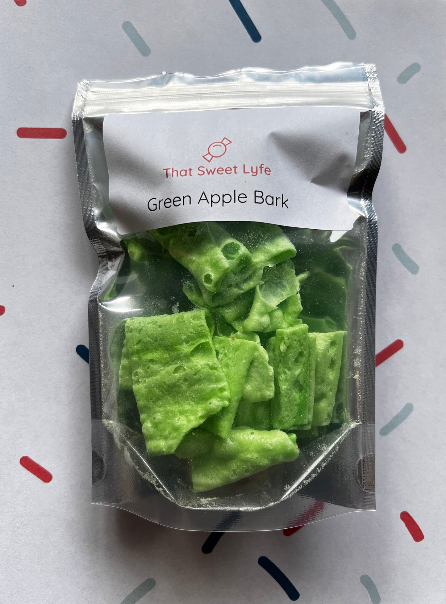 Silver zip-close bag filled with green freeze-dried jolly ranchers bark