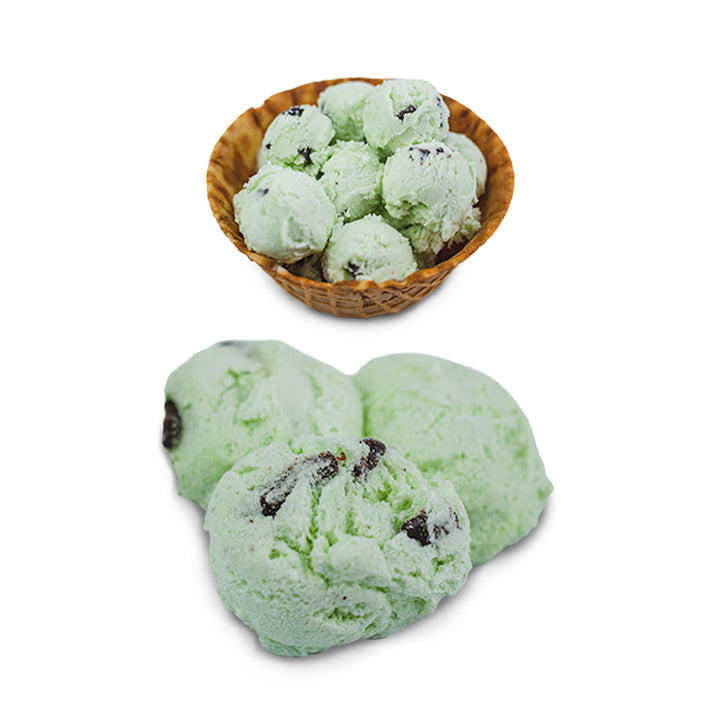 3 scoops of freeze-dried mint chocolate chip ice cream beside waffle bowl of regular ice cream
